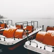 ac864ab9-ffb0-4683-9961-79252fd1ffc1-orange-paddleboats-by-pier-calm-lake-captured-foggy-winter-day.jpg